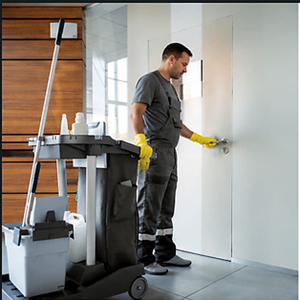 Gemsha Services team member cleaning a client entryway