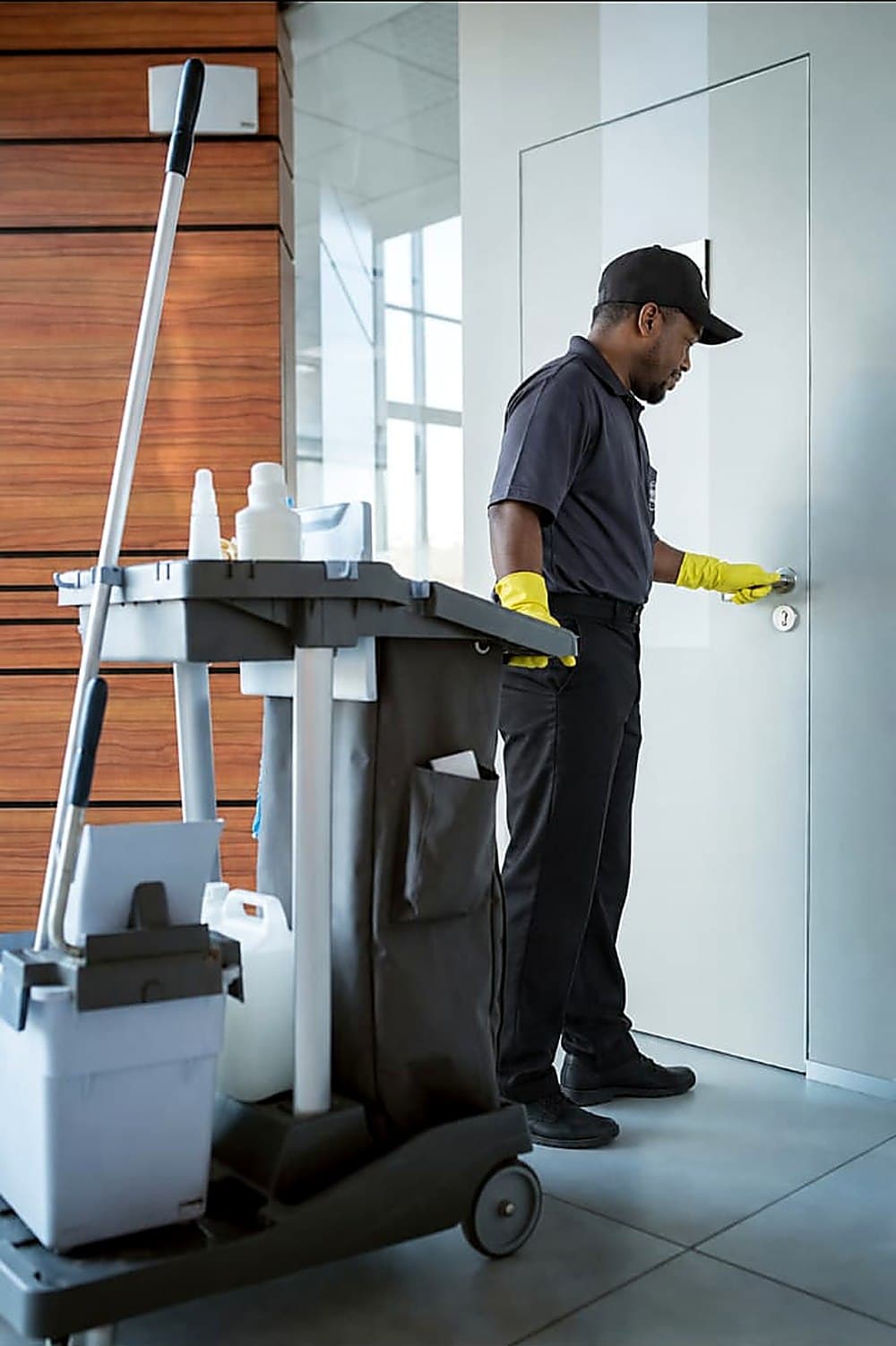 Gemsha Services team member cleaning a client entryway